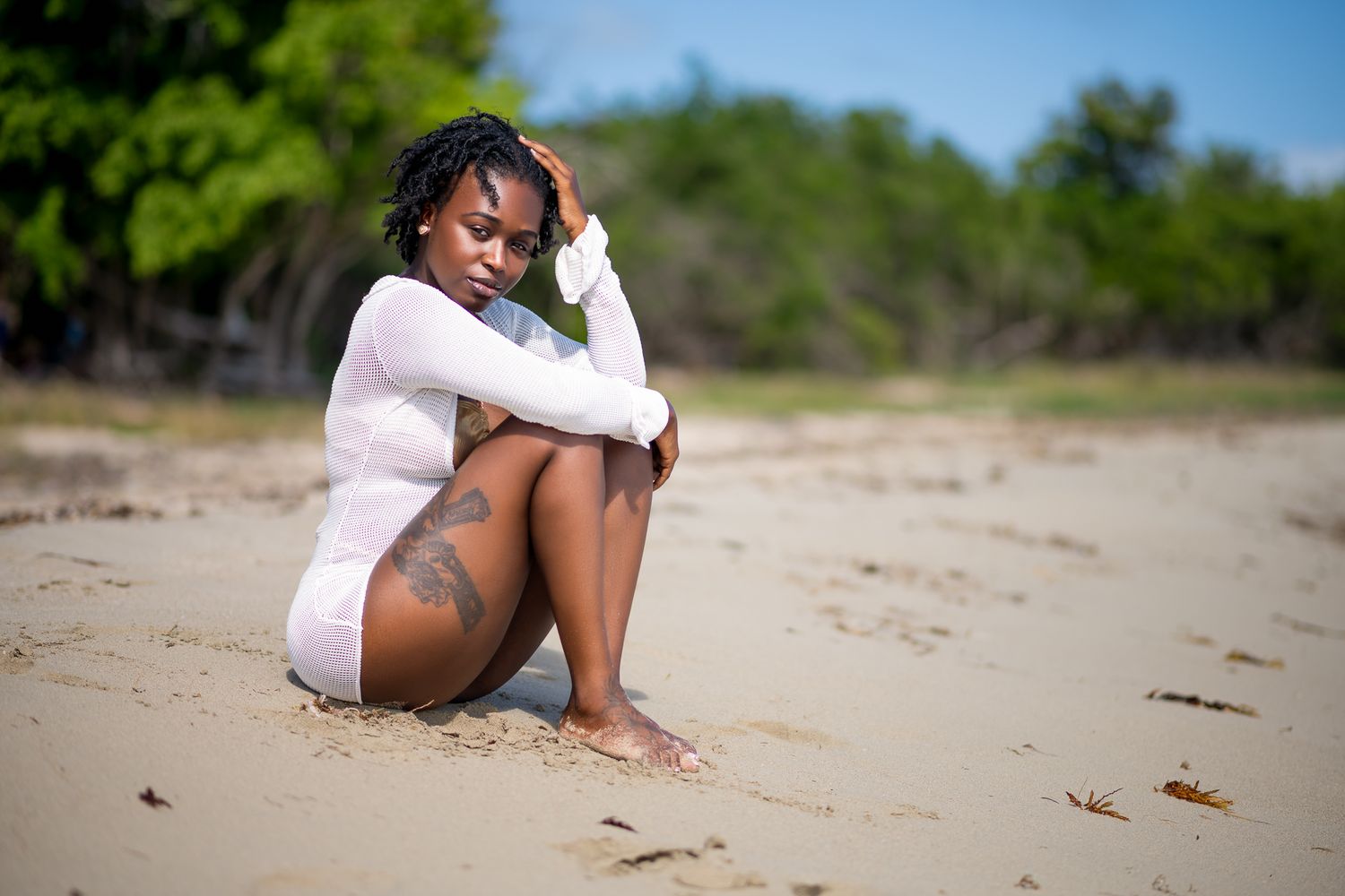 Person posing on a sunny beach wearing casual attire in multiple artistic shots.
