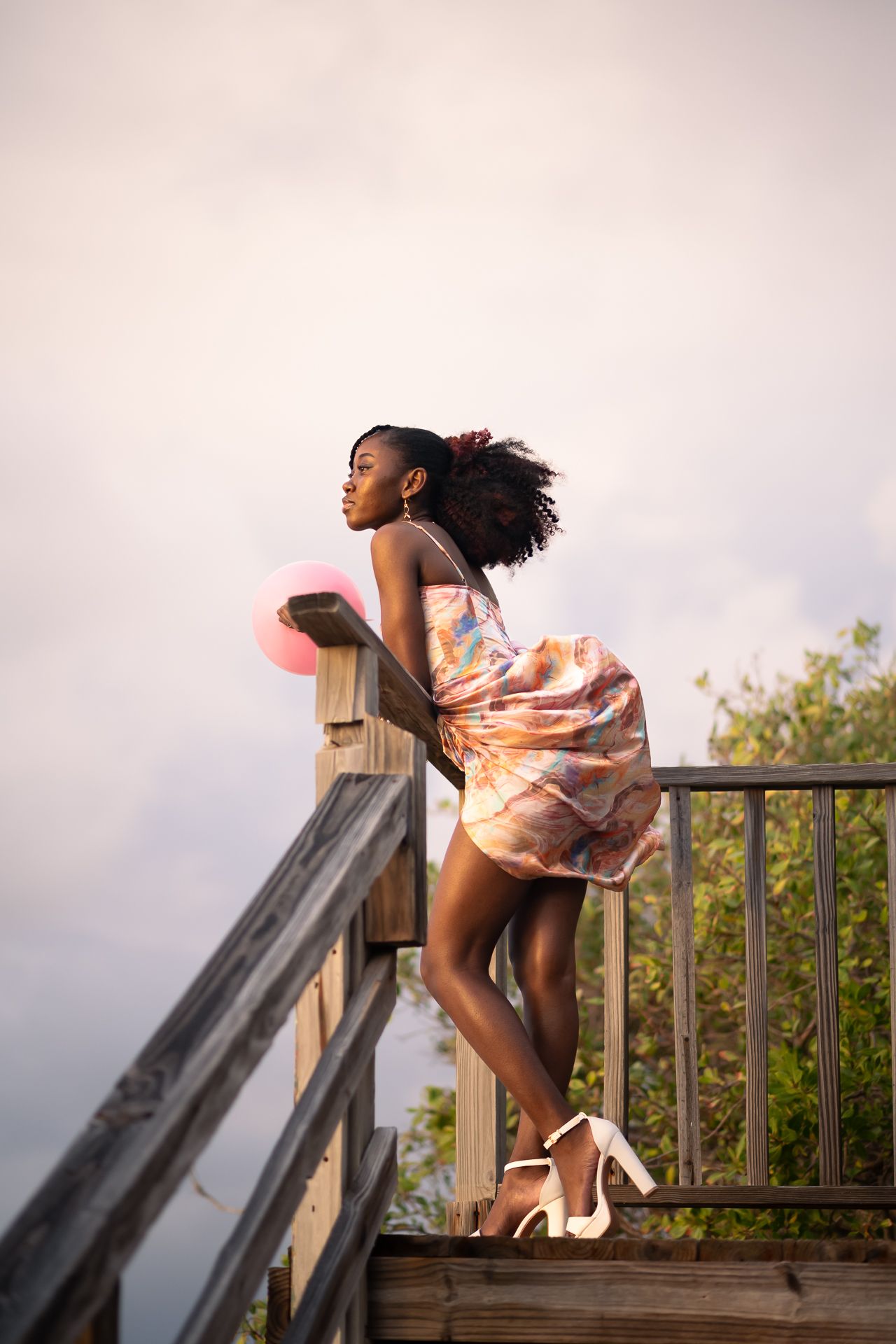 Dynamic motion shots of someone in flowing dress twirling on a wooden deck at sunset.