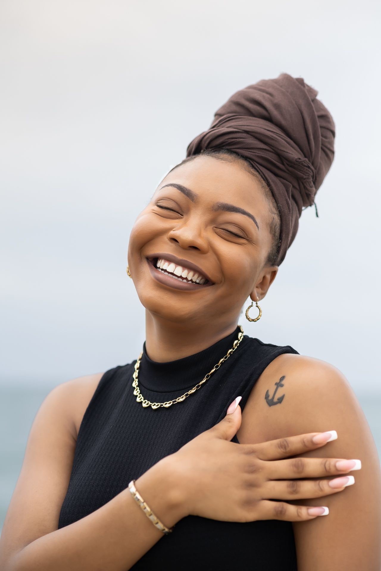 Expressive portrait series in black turtleneck showing joyful emotions and jewelry details.