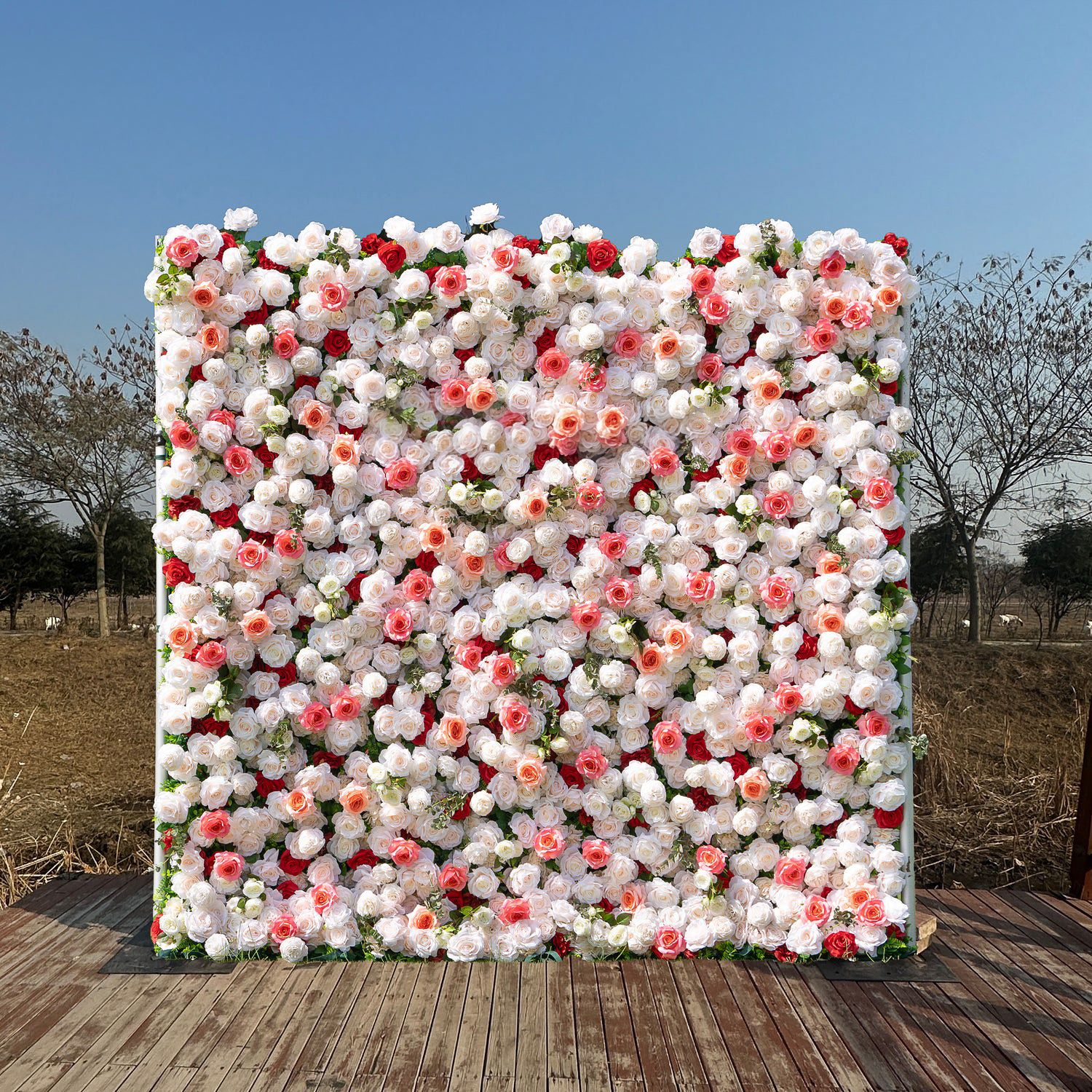 Pink and white flower wall backdrop with dense artificial blooms for events.