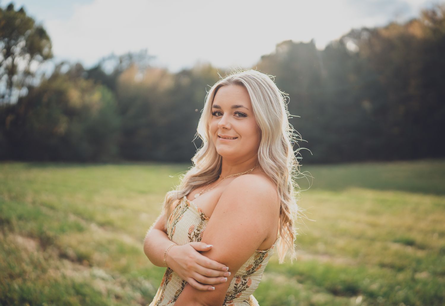 A series of outdoor portrait photos taken in a sunlit meadow with golden hour lighting and natural scenery.