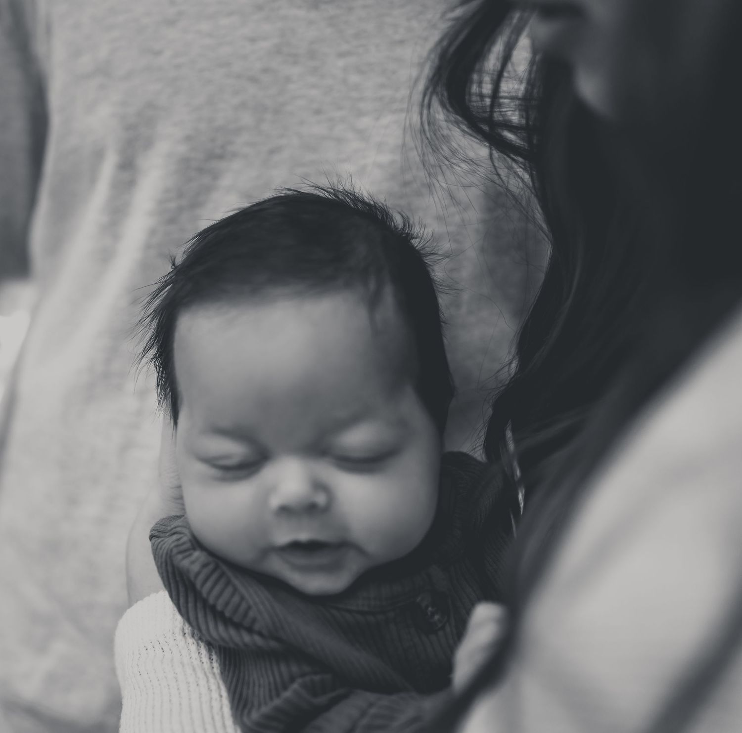 Black and white photo series showing a sleeping baby in various peaceful poses.