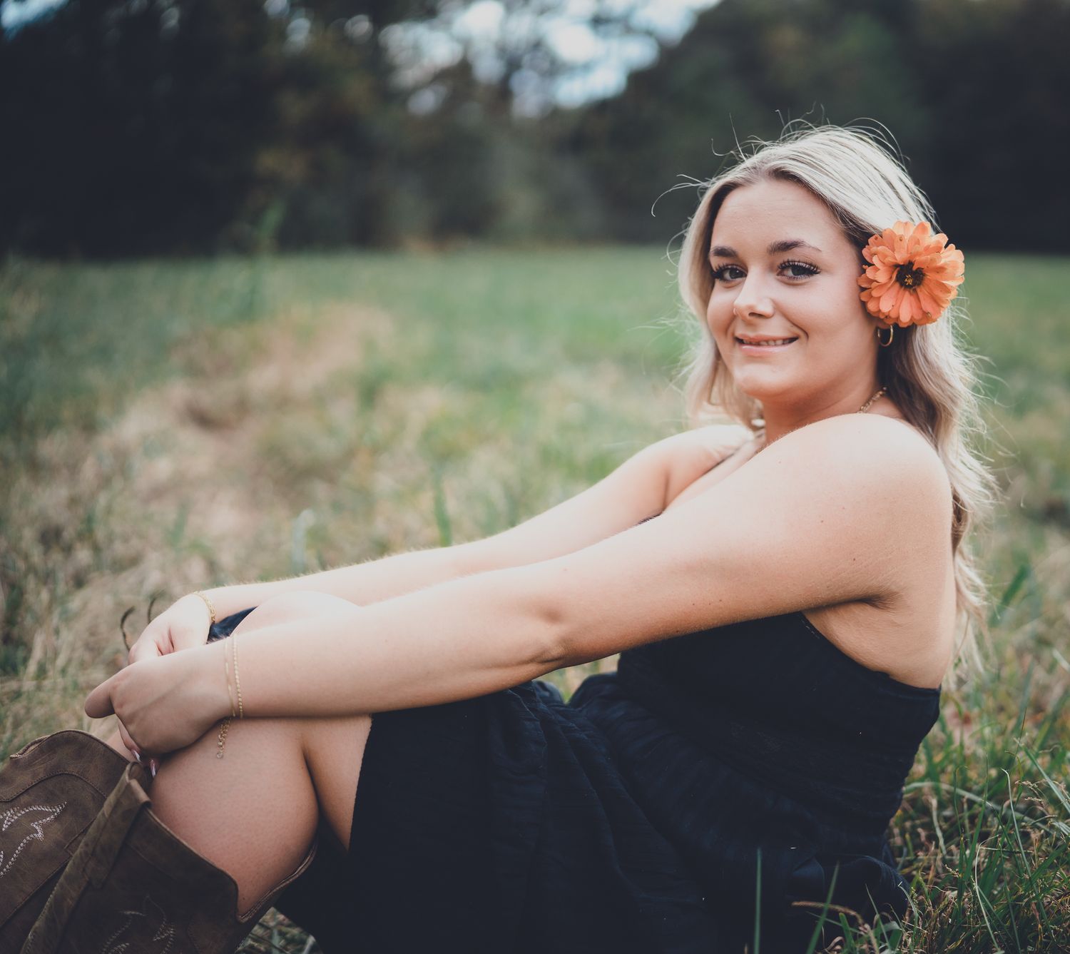 A series of dreamy outdoor portrait shots in a field at sunset with soft natural lighting and floral accents.