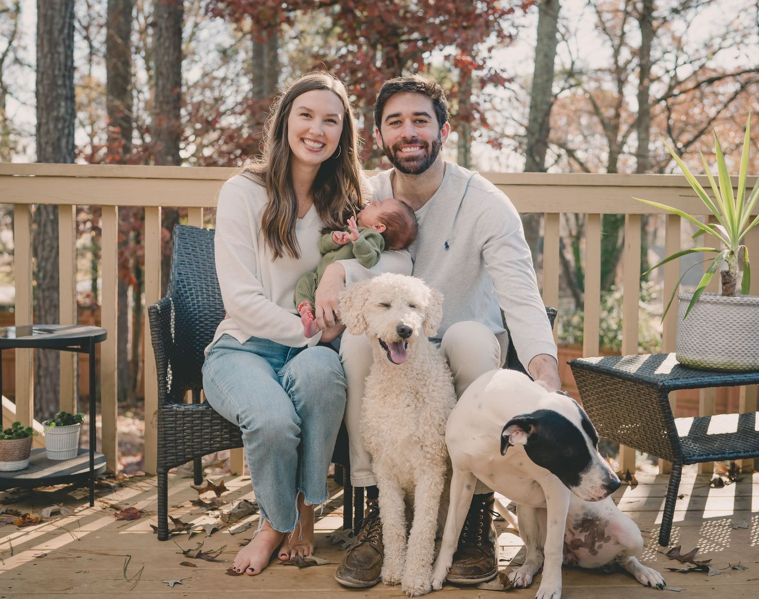 Outdoor family photoshoot series featuring a couple and their fluffy white dog in a wooded setting.