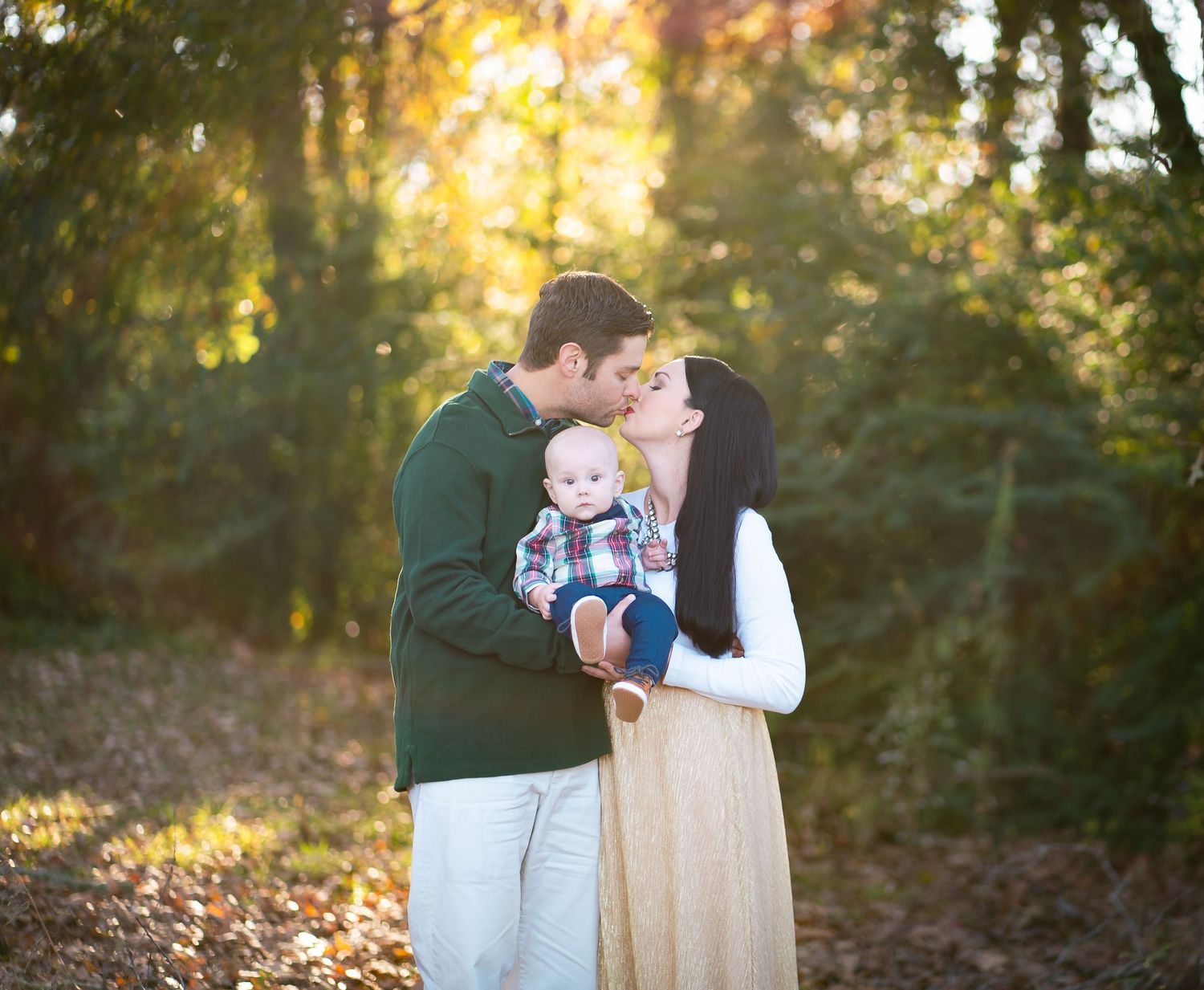 Romantic sunset family portrait in wooded setting.