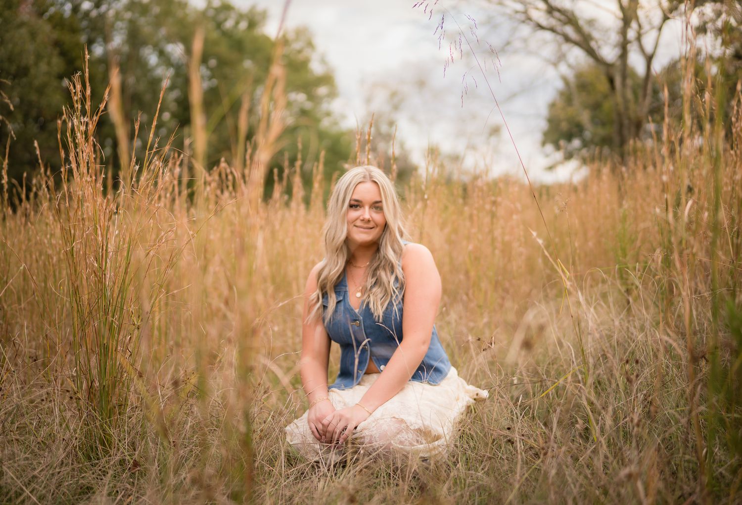 Artistic lifestyle photography in a rustic field setting with natural sunlight filtering through autumn grass.