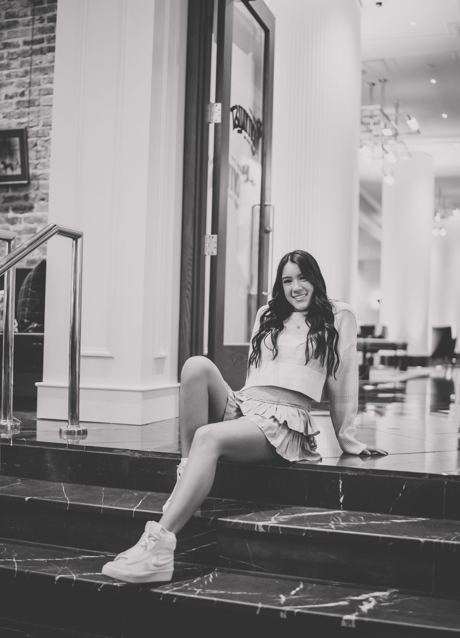 A series of black and white photographs showing a person lounging on a windowsill in an indoor setting.