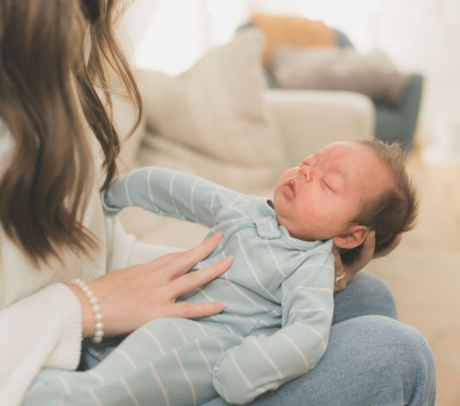 Lifestyle photos of a sleeping baby in light blue clothing on a couch.