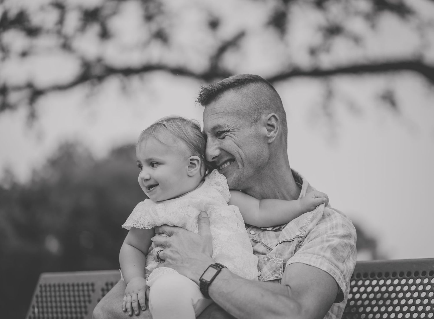 Black and white photo showing a heartwarming moment shared on an outdoor bench.