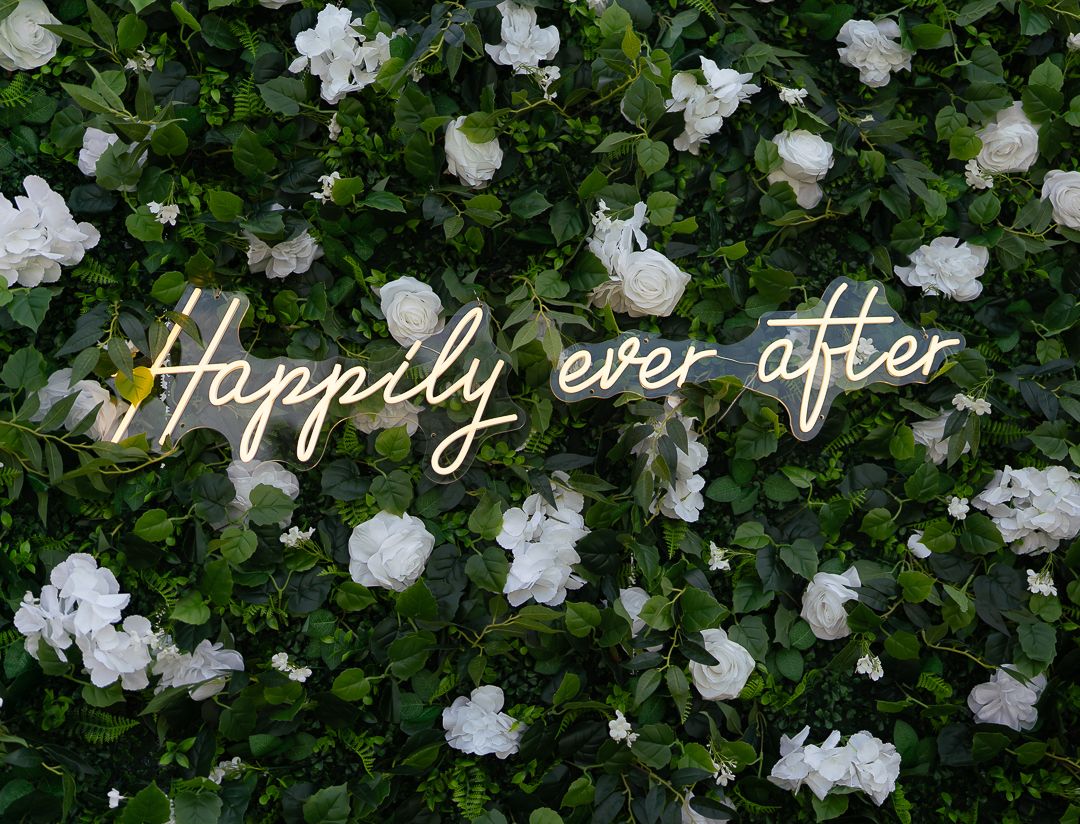 White gardenias blooming against lush green foliage in a garden setting.