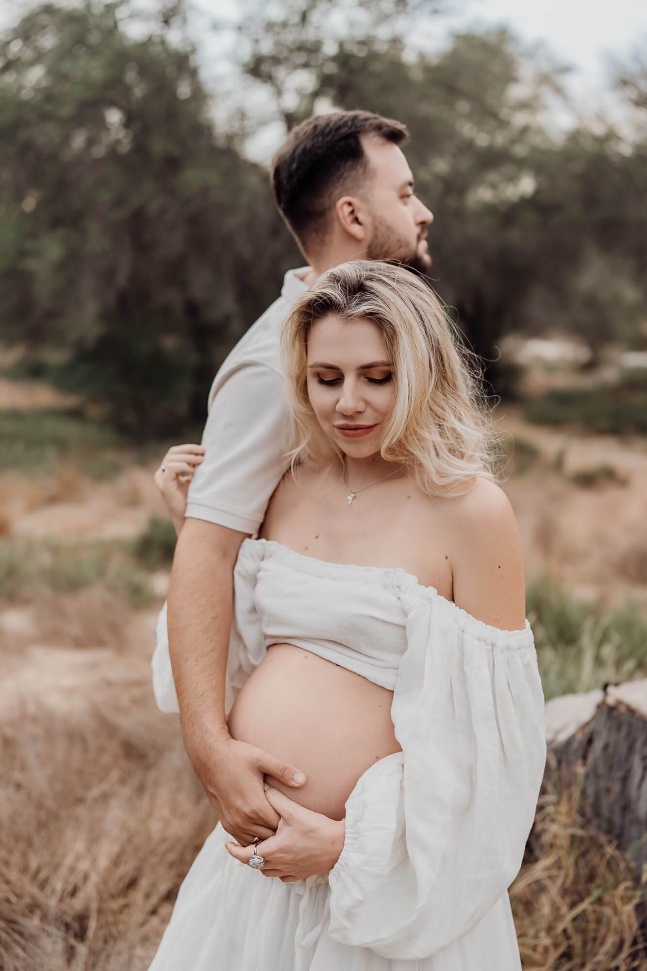 Intimate maternity portrait session in natural setting with soft afternoon light.