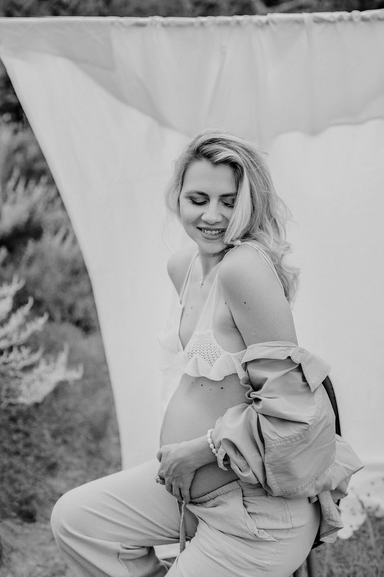 Artistic black and white portrait series with ethereal white fabric backdrop.