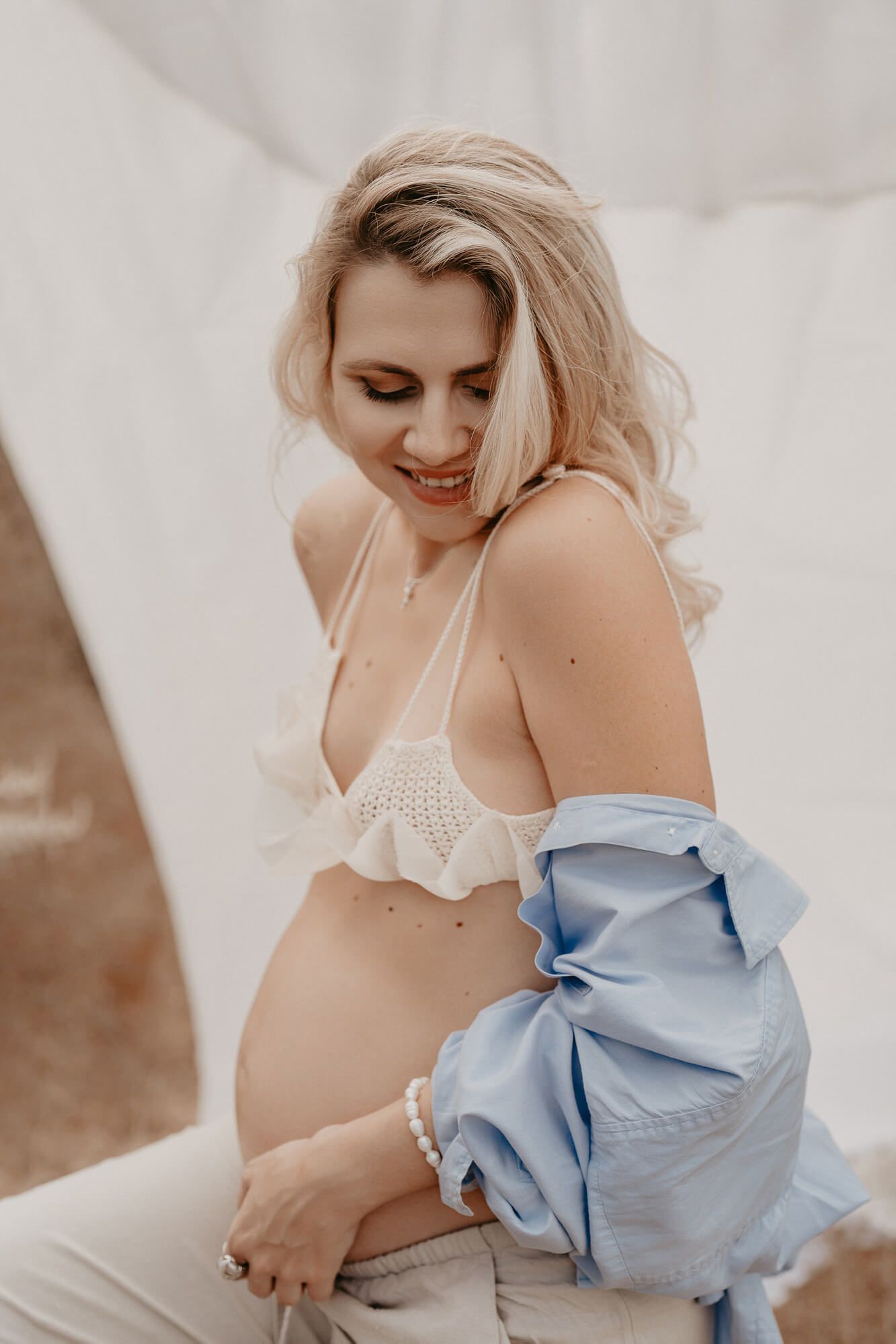 Intimate portrait session with delicate lace details and soft lighting.