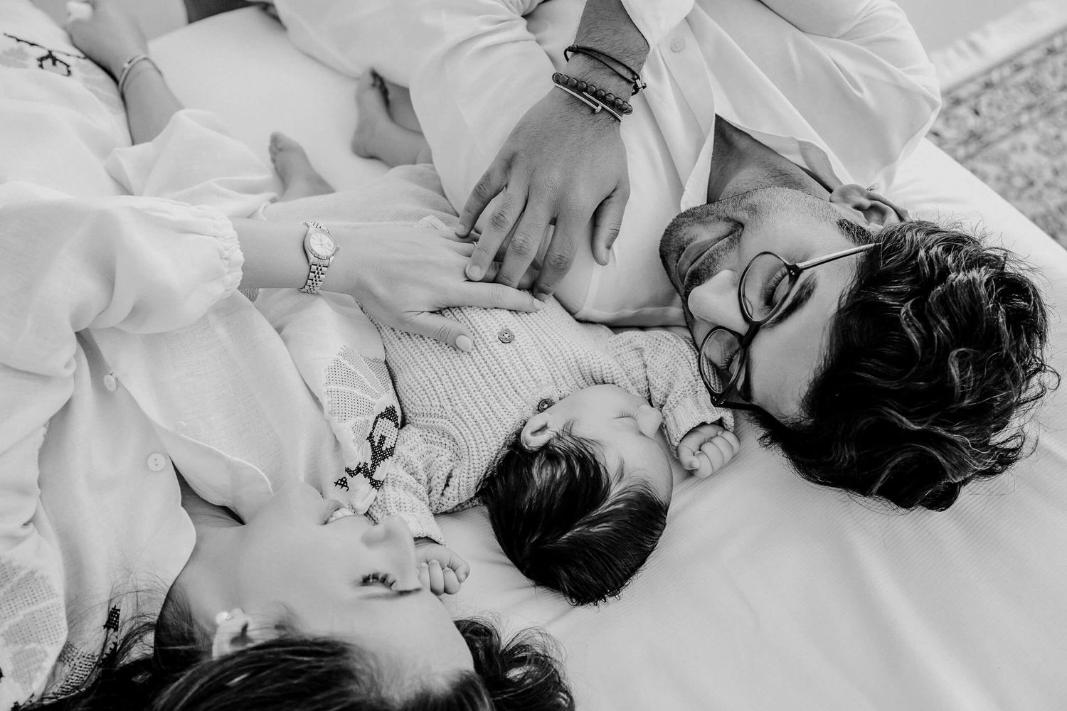 Black and white portrait of family sharing affectionate moments together.