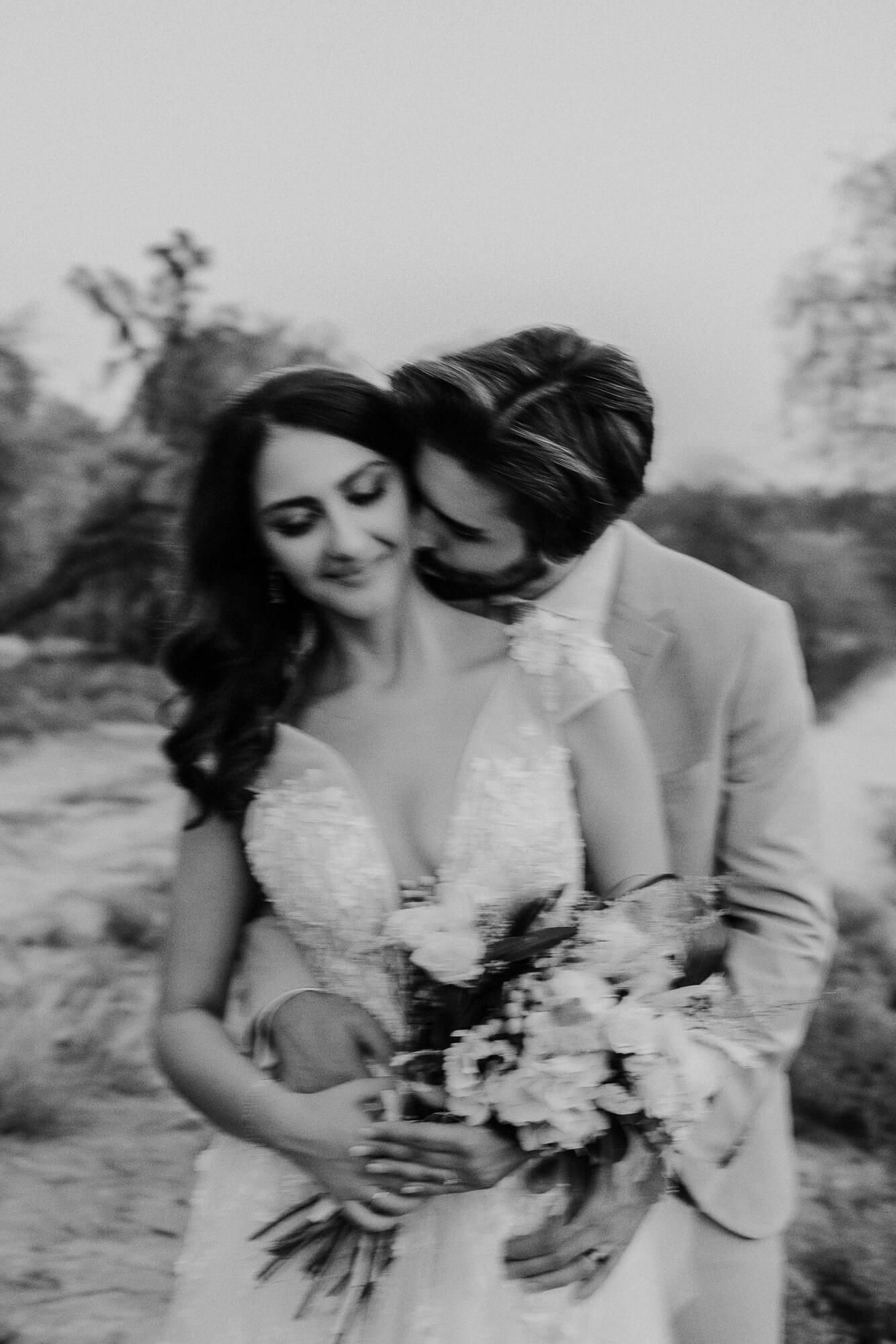 Black and white wedding portrait series showing intimate moments between a couple in embrace outdoors.