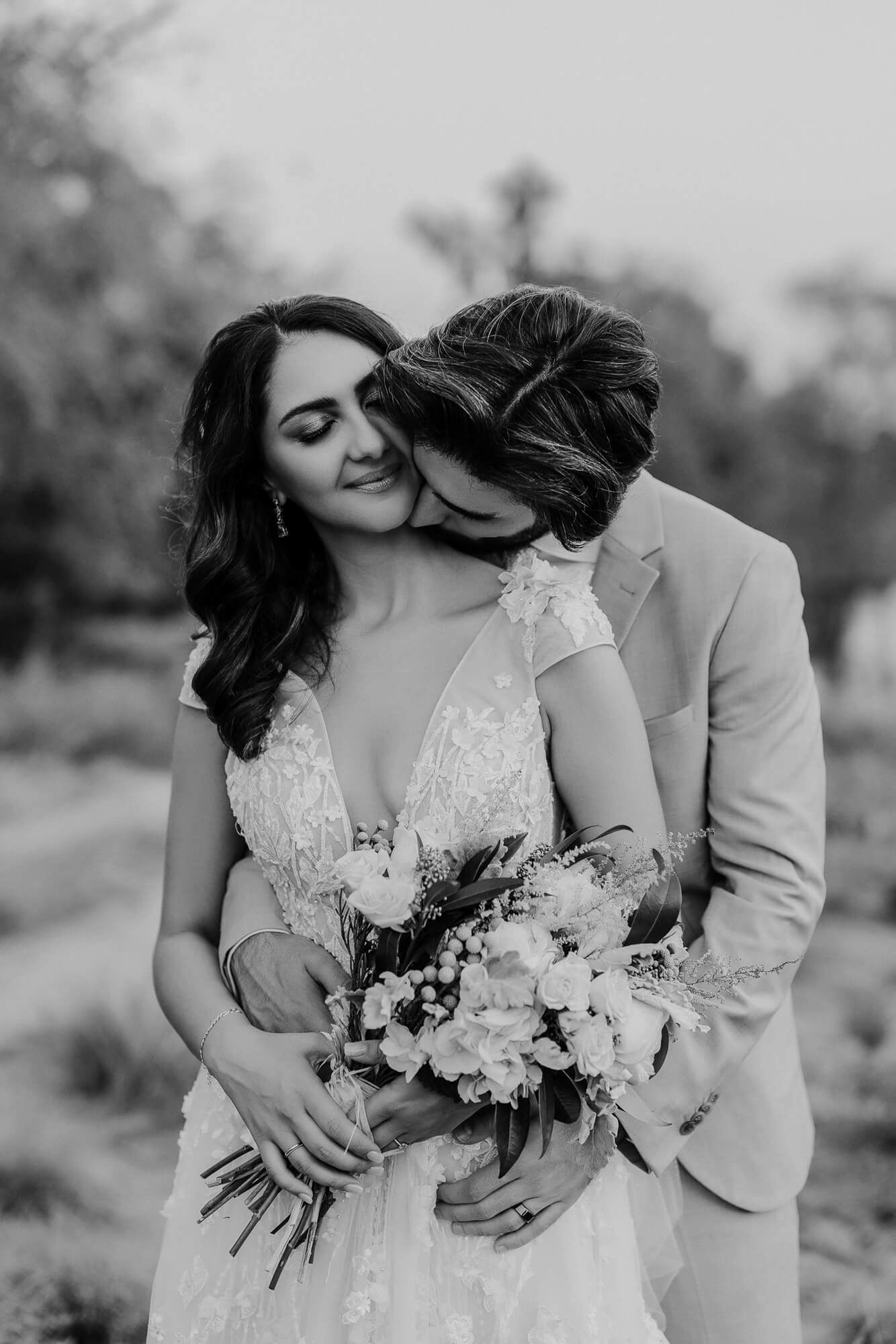 Romantic black and white wedding photo series showing tender moments between newlyweds with bridal bouquet and intimate poses.