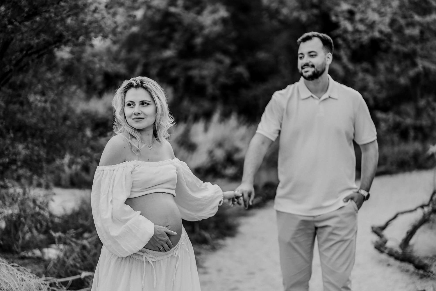 Natural light maternity photography showcasing joyful moments in a desert setting.