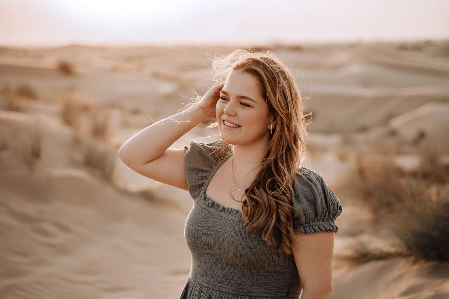 Artistic portrait series in desert setting with warm sunset lighting and sandy backdrop.