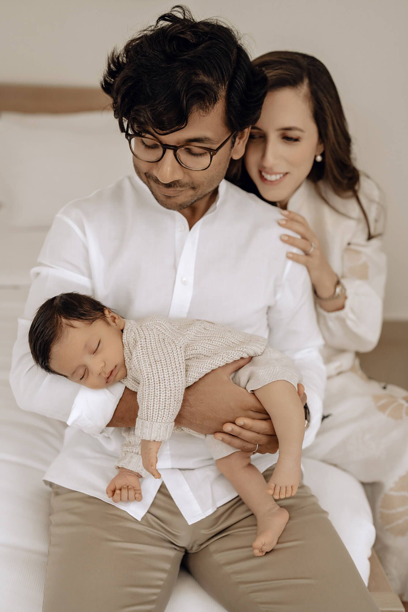 Natural lifestyle family portrait in neutral tones showing affectionate moments together.
