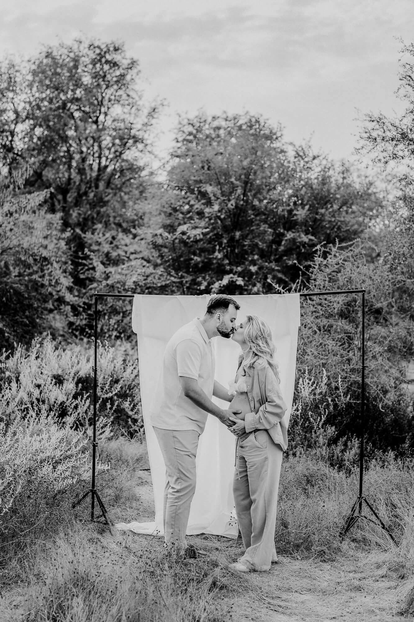 Black and white capture of intimate outdoor portrait session with natural desert backdrop.