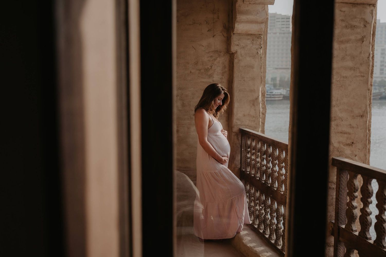 Person in lingerie poses elegantly against vintage stone railing in a series of artistic boudoir photographs.