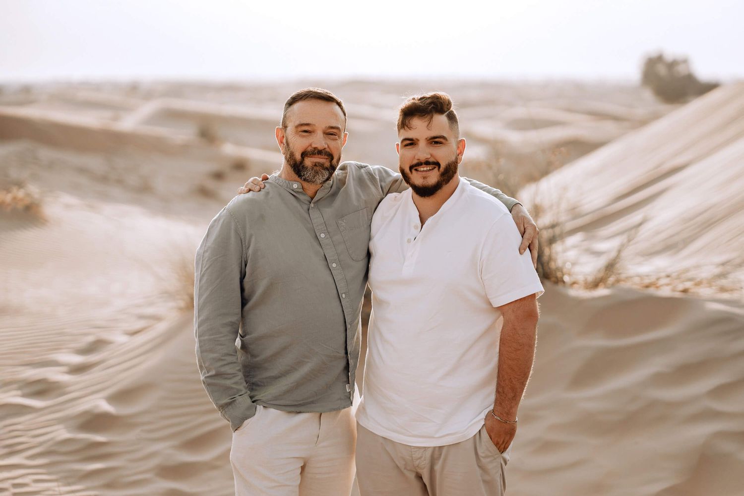Sand dunes provide romantic backdrop for couple's casual desert photoshoot.