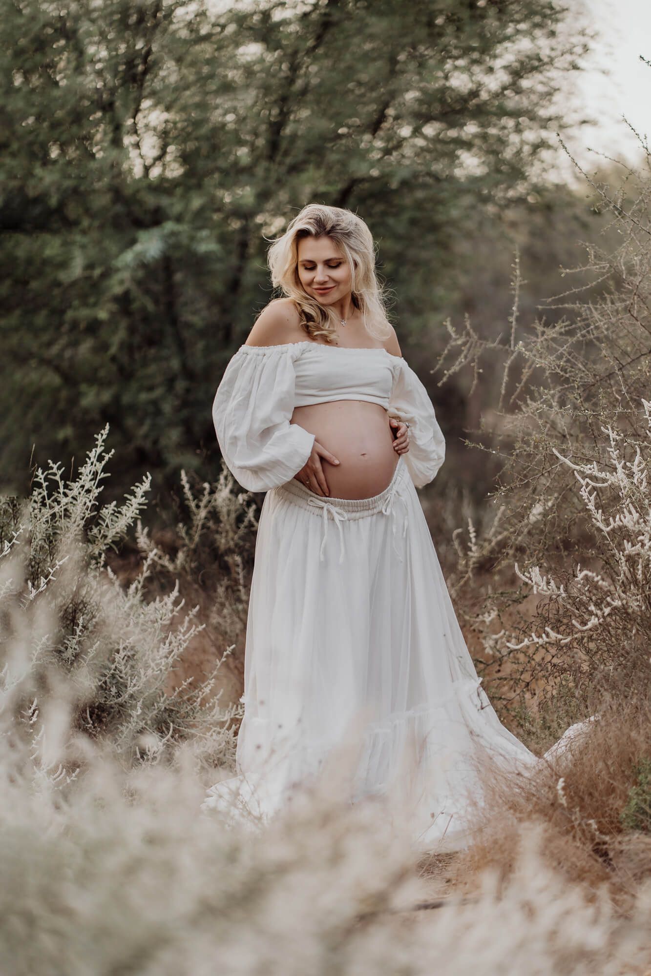 Artistic maternity photography sequence in outdoor natural setting.