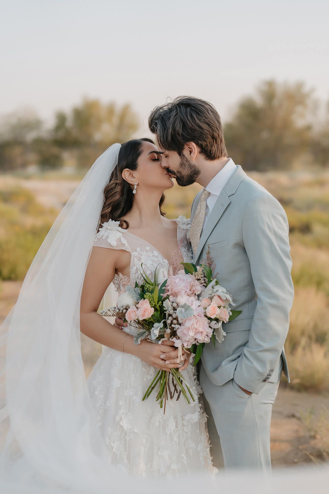 A tender wedding photo sequence in muted tones showing a couple's intimate moments with pink floral bouquet details.