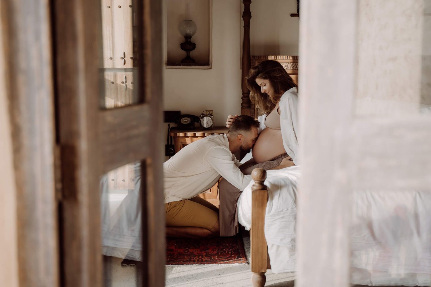 Interior bedroom scene with warm sepia tones showing someone relaxing on bed while reading in natural light.