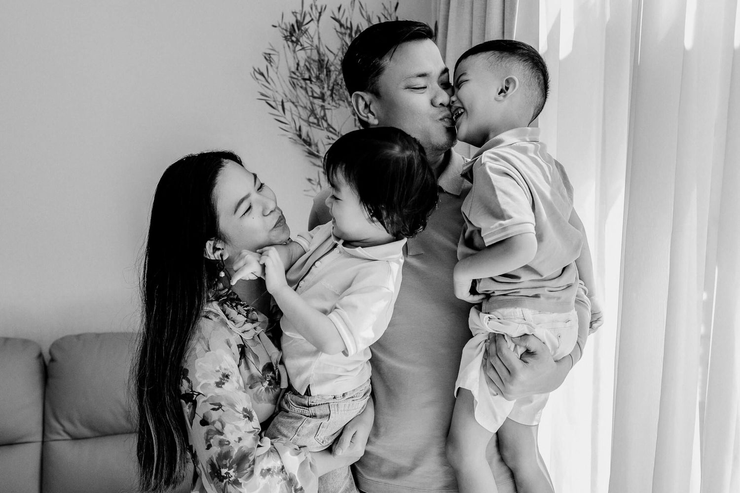 Black and white photo collage showing tender intimate moments between two people in front of white curtains.
