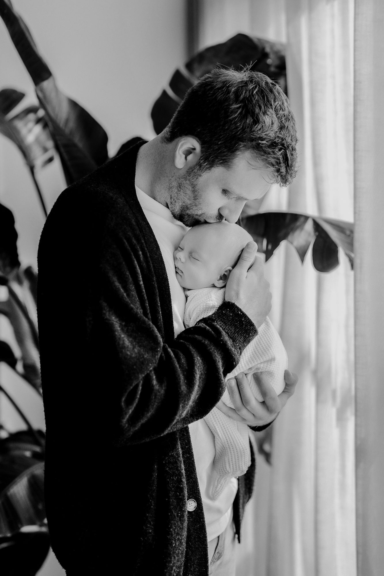 Black and white photograph showing intimate romantic embrace between two figures in a tender moment.