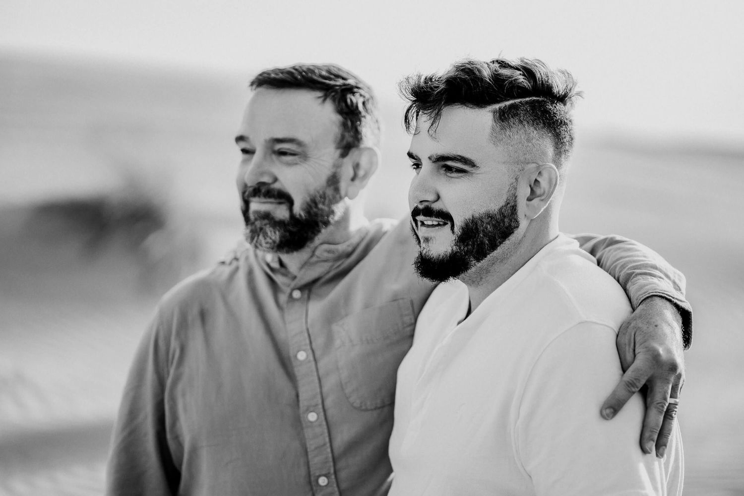 Monochrome desert photo showing genuine happiness between two people embracing.