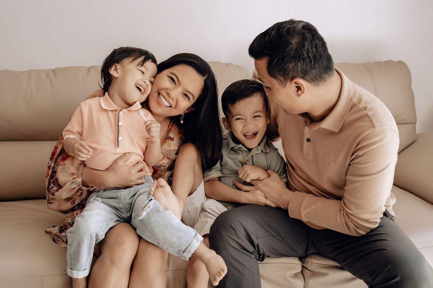 A series of candid family photographs showing tender moments between parents and child relaxing together at home.