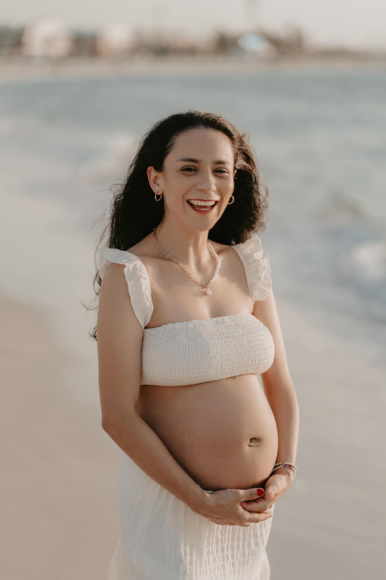 A person wearing a white dress stands by the beach at sunset, captured in a candid sequence of joyful moments.