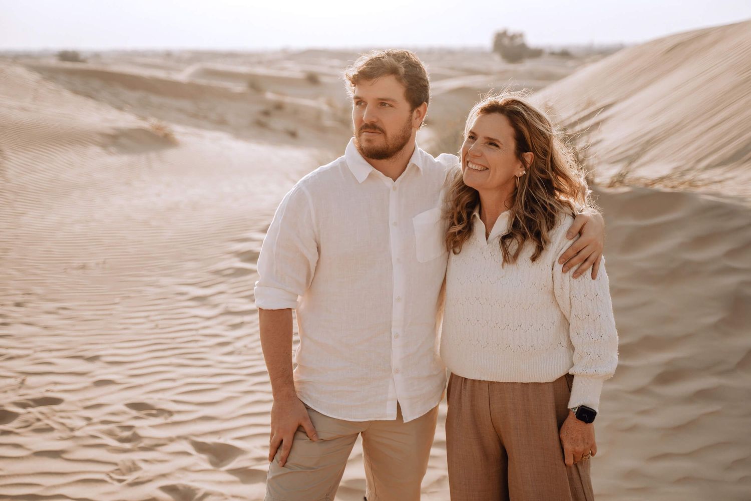 Warm-toned desert portrait featuring coordinated casual outfits and natural landscape.