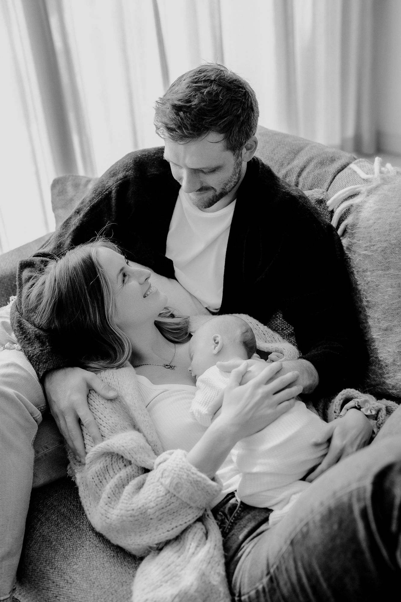 A series of four black and white romantic photos showing an intimate kissing sequence between a couple.
