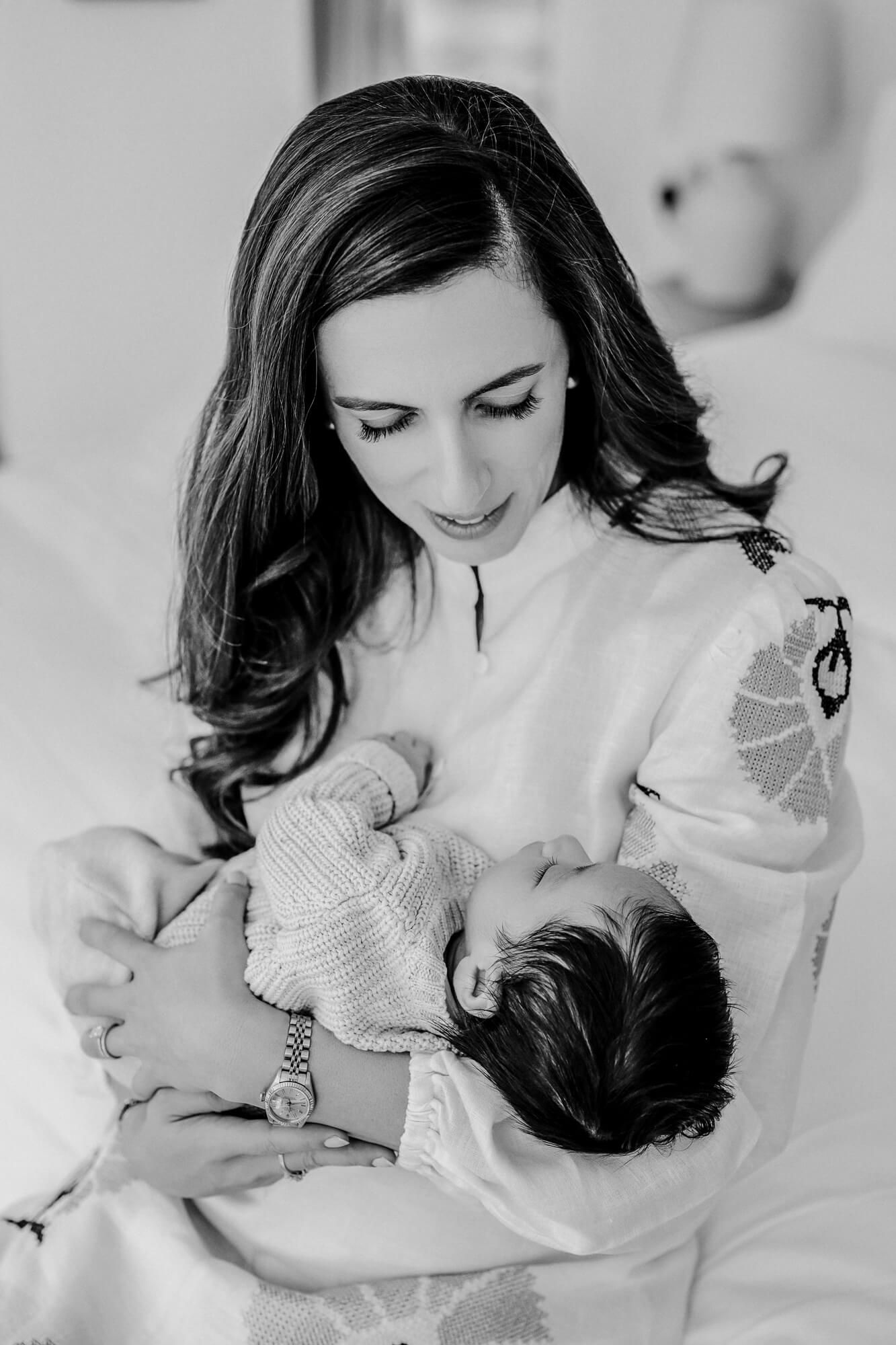 Black and white series showing gentle moments between parent and infant.