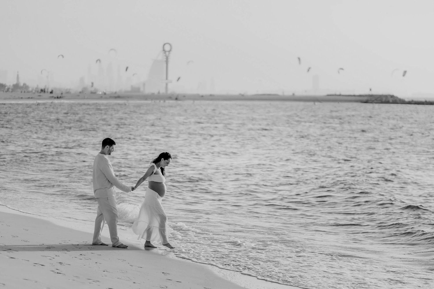 A beach photoshoot sequence showing silhouettes of people posing near the ocean at dusk.