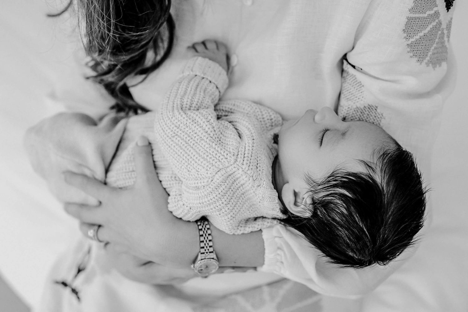 Series of black and white photographs showing parent and baby bonding moments.