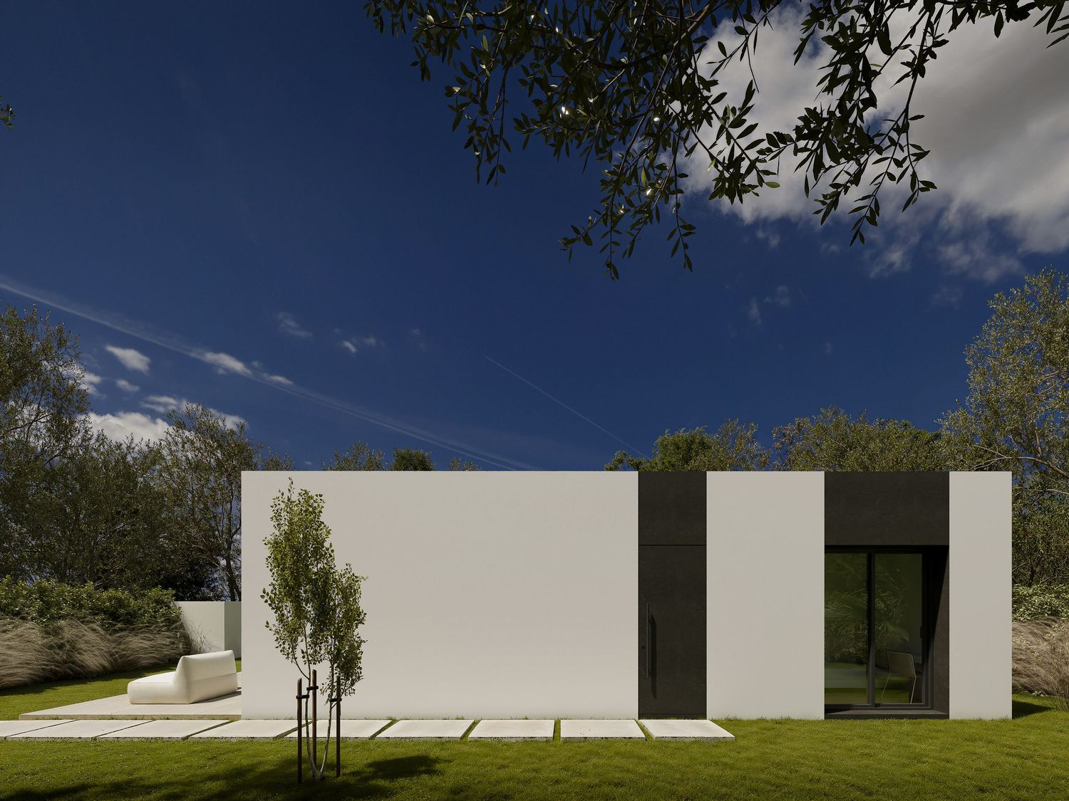 Series of white modern architectural walls creating geometric shapes against a blue sky and green landscape.