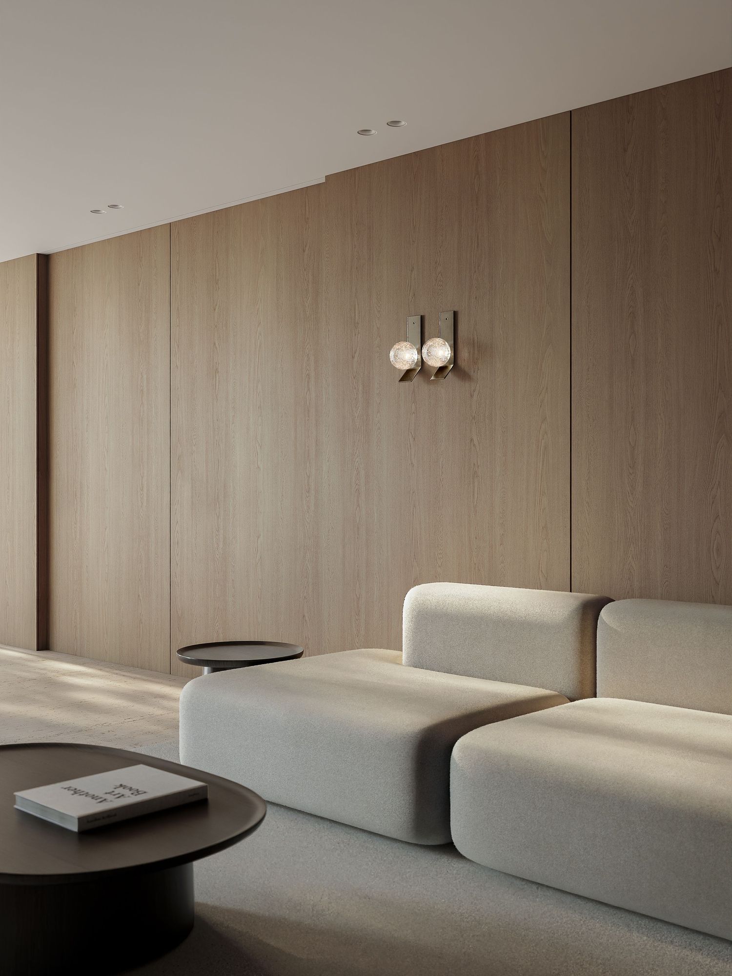 Minimalist beige interior with a long curved wall and modern ceiling light fixture creates an elegant flowing space.