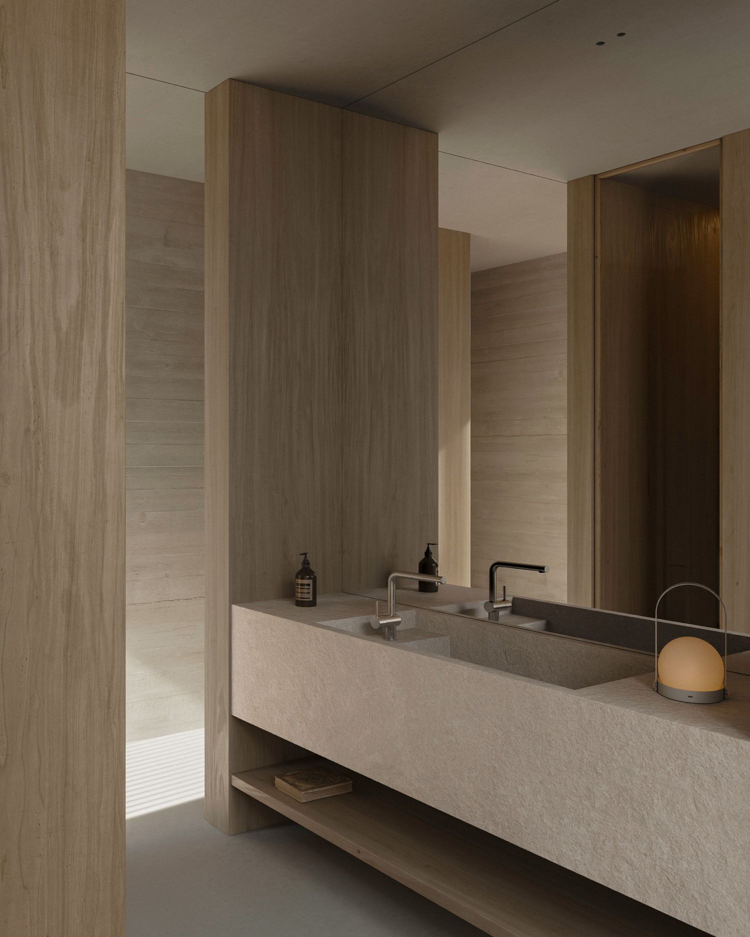 Modern minimalist bathroom with beige stone vanity, wooden walls and soft lighting in neutral earth tones.