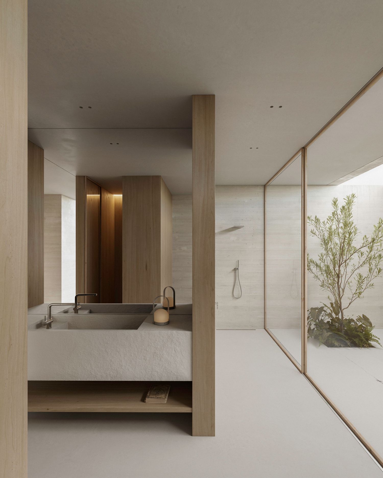 Modern minimalist bathroom with floating vanity, stone sink and glass-enclosed shower featuring a serene outdoor garden view.