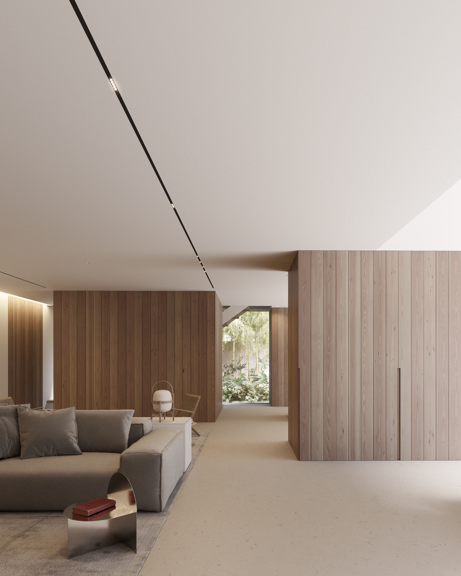Modern minimalist living room with gray sofa, wood panel walls, and concealed lighting along white ceiling track.