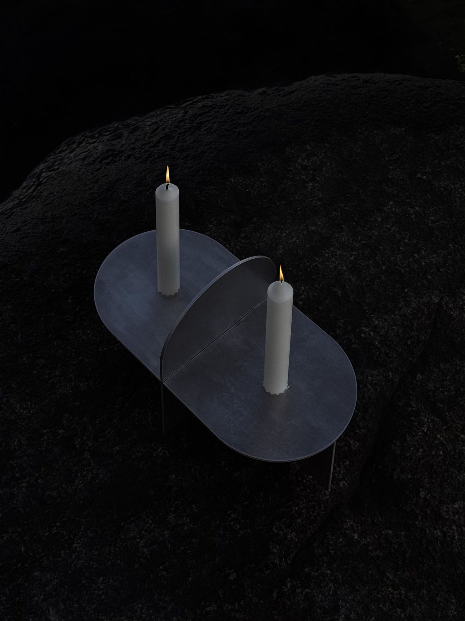 A white candle on a reflective surface creates a dramatic shadow against a dark background in a time-lapse sequence.