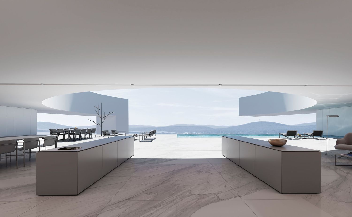 Modern minimalist kitchen with sleek gray counters opens to infinity pool and ocean view through panoramic windows.