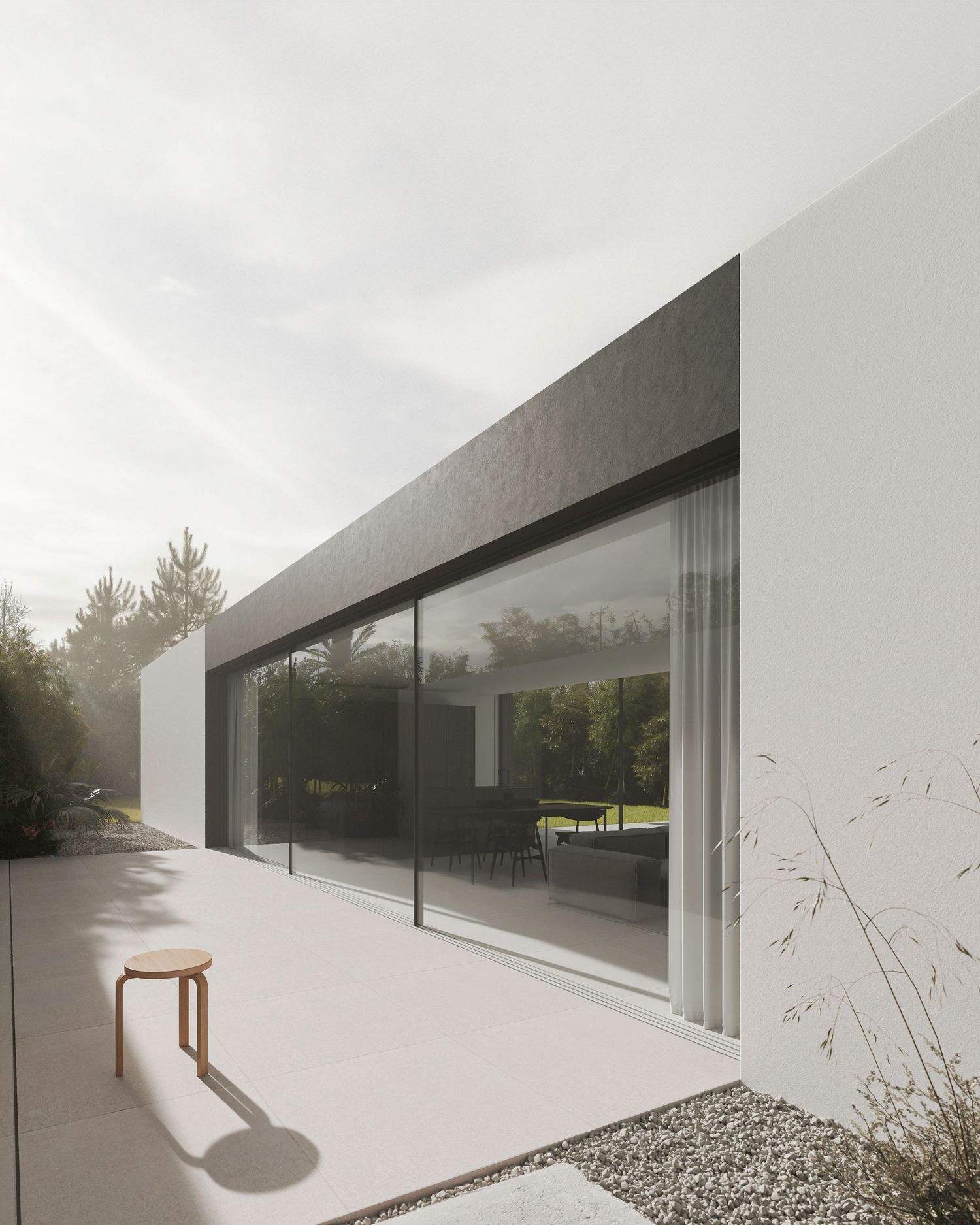 Modern minimalist house exterior with large glass window, white walls, and a wooden stool casting shadow in natural light.