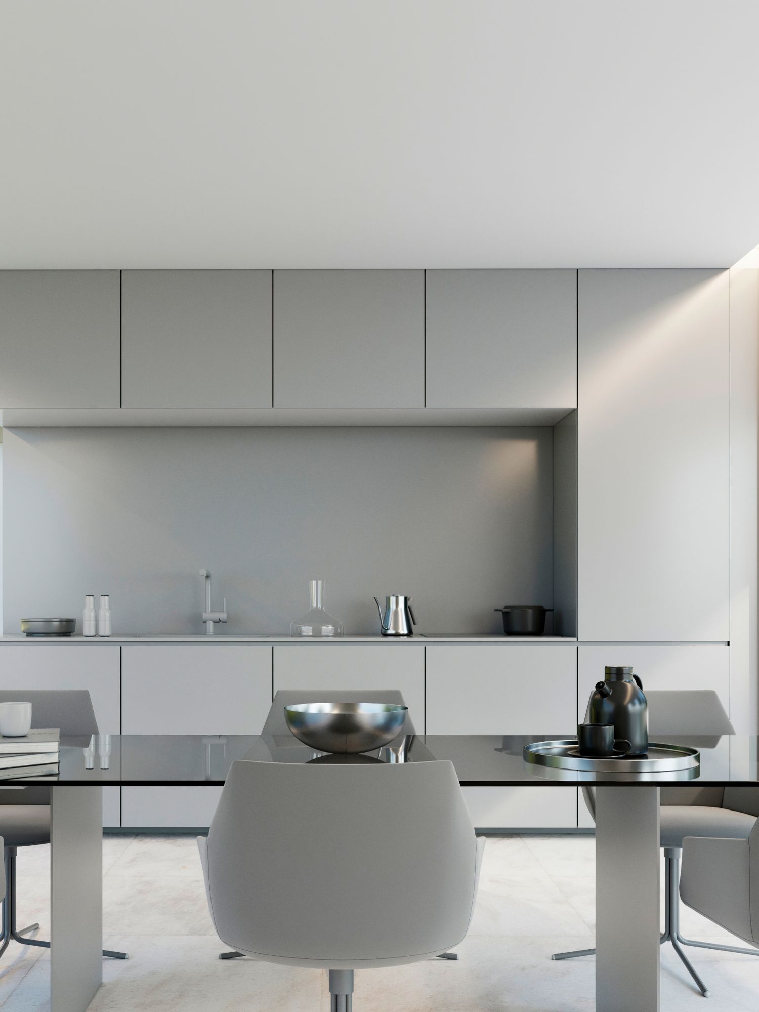 Modern minimalist kitchen and dining area with sleek grey cabinets, white walls and contemporary furniture.