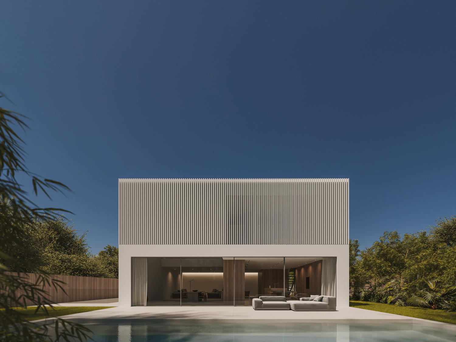 Contemporary white villa with open-plan design and swimming pool in tropical garden setting.