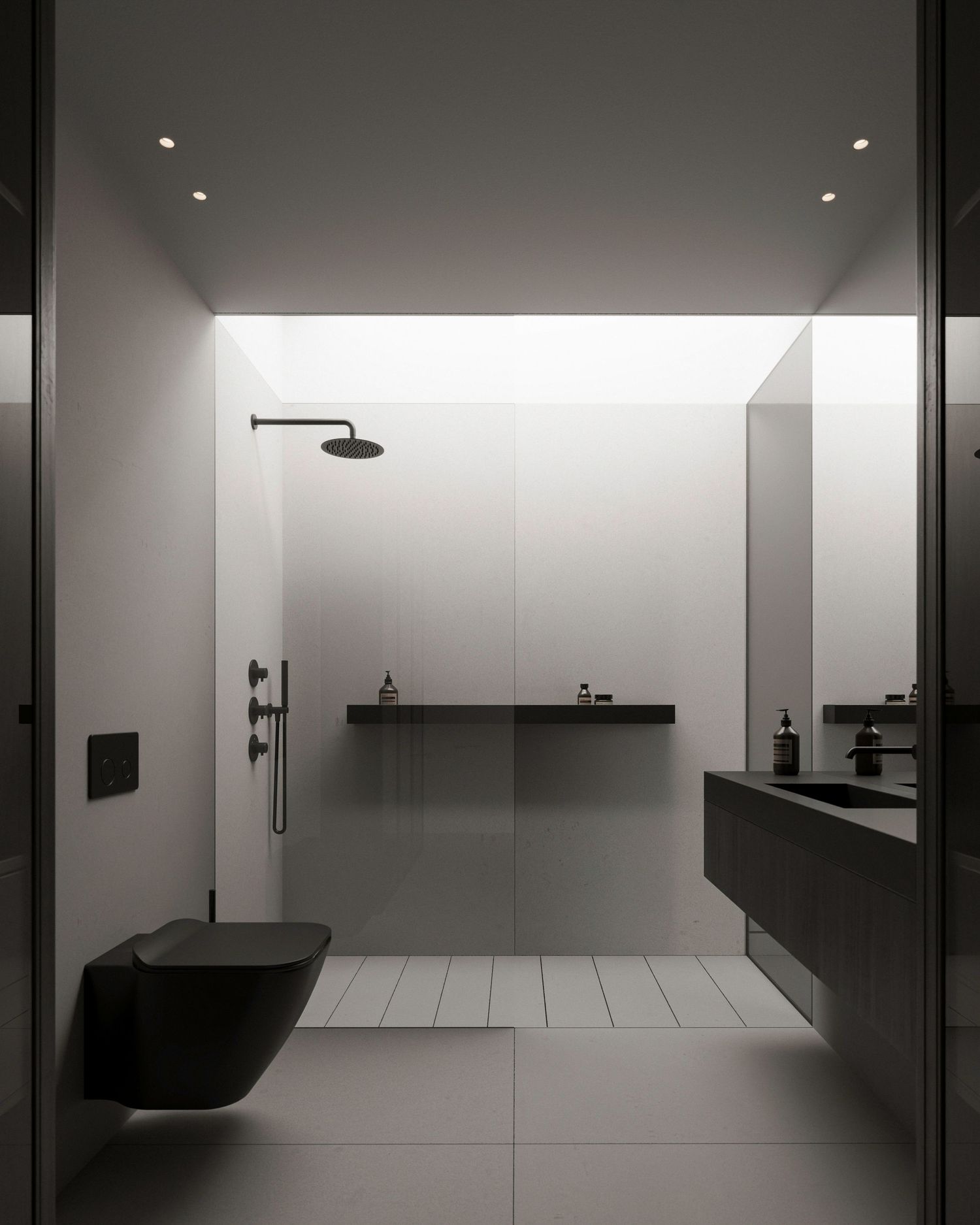 Minimalist black and white bathroom with floating vanity, wall-mounted toilet, and sleek rainfall shower head.
